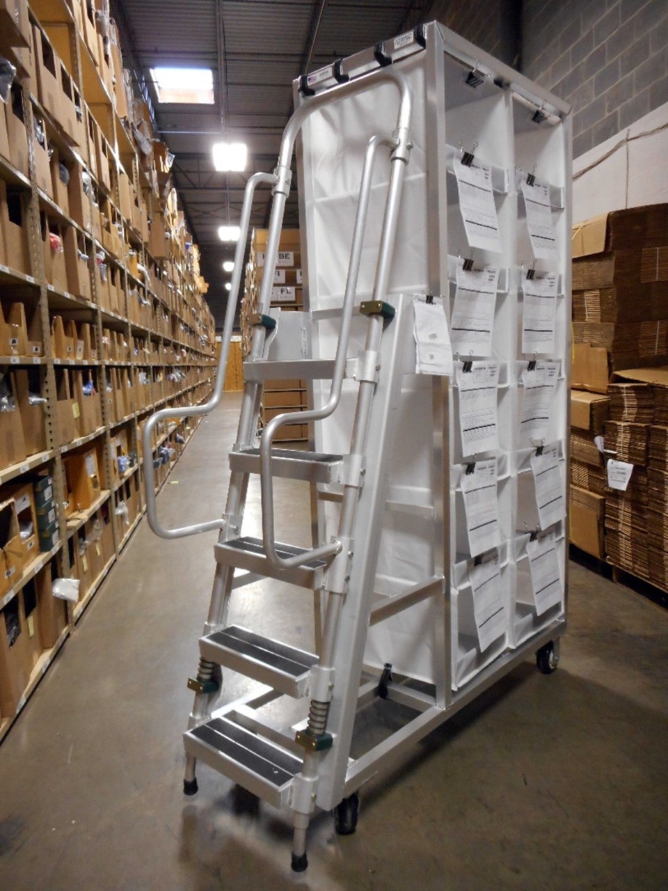 A two-sided cubby cart, used to pick up 24 orders at a time. The cart also includes an attached five-step ladder.