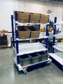 Order Picker Cart designed to pick 9 orders at once direct to cardboard shipper and area was incorporated below for empty plastic totes. 